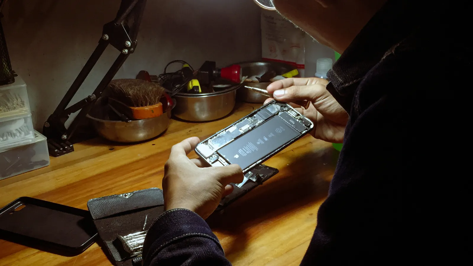 A technician repairing a smartphone