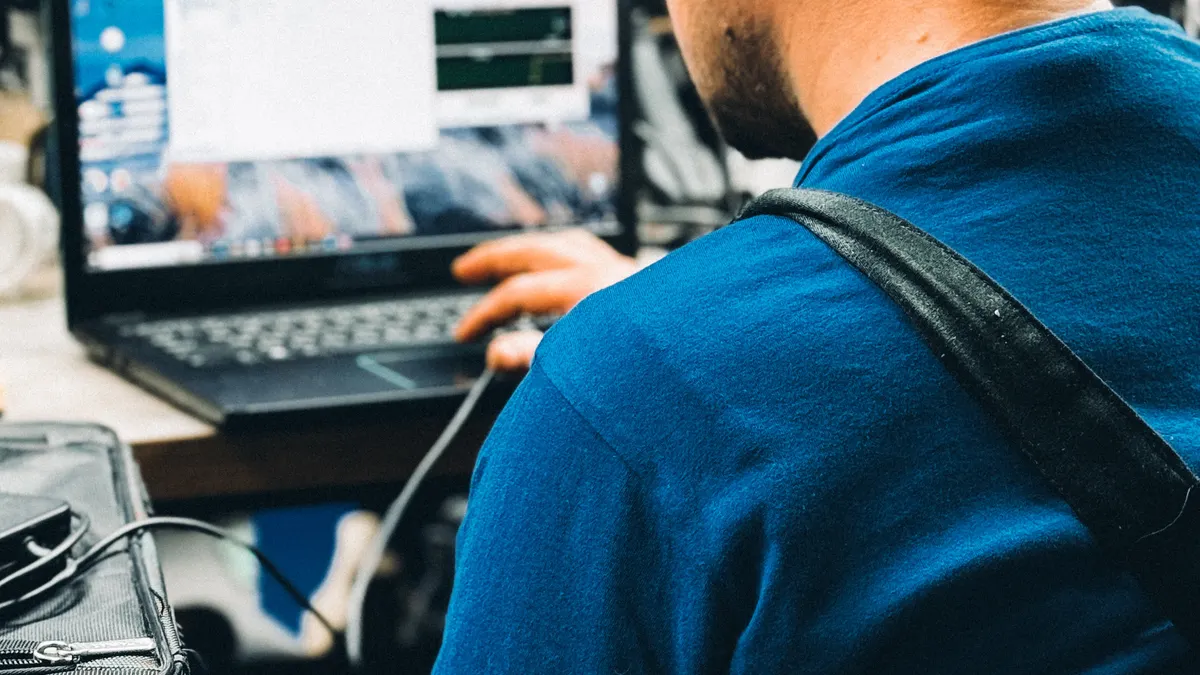 A mobile technician working on a laptop at a customer's location
